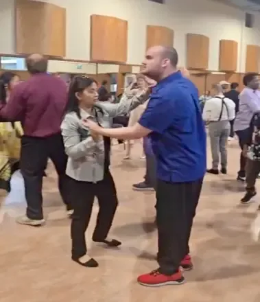 Clients and staff dancing together on the floor at the Client Appreciation Event