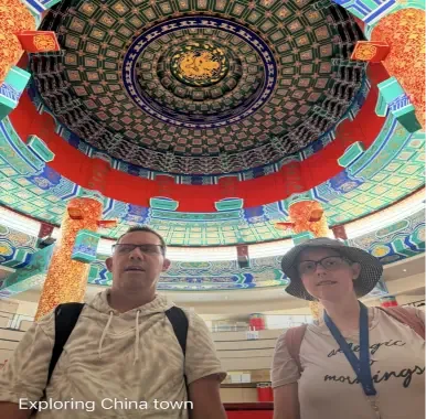 Clients exploring Calgary Chinatown beneath the decorated cultural centre dome