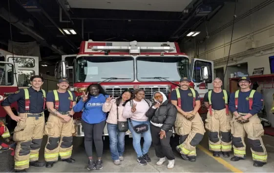 Clients and staff with firefighters during a visit to a Calgary fire station