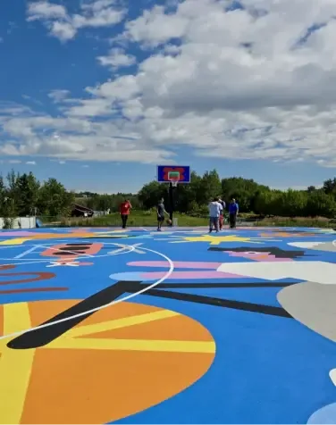 A large colourful public art mural painted on a Calgary pathway
