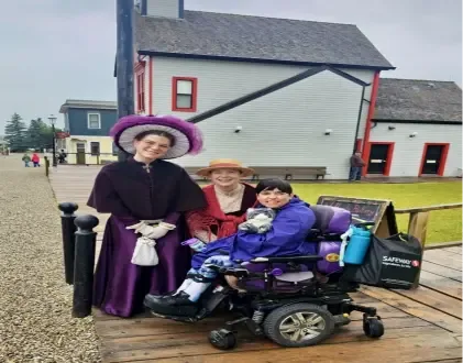 Clients and staff in period costume outside a historic building at Heritage Park