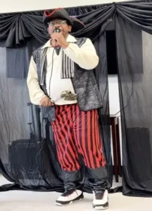 A Theatre Club performer in costume on stage during a Resourceful Futures production